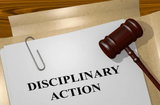  /></figure>
<p>Disciplinary action refers to the measures taken by an enforcing body in response to violations of rules, codes of conduct, or moral principles in a particular industry.</p>
<p>This procedure is frequently used to punish people who have been shown to have engaged in misbehavior, negligence, or other actions that go against the accepted norms in their field of expertise.</p>
<p>The relevant governing or licensing authority is typically the one to initiate disciplinary action in regulated fields like law, medicine, finance, or other professions. This regulatory body investigates complaints, renders decisions, and reviews documentation to determine whether a licensed professional has broken any laws governing their industry.</p>
<p>Depending on the specific laws in force and the seriousness of the offense, disciplinary actions might take many different forms.</p>
<h2 id=